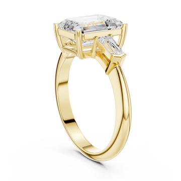 Emerald petite baguette three stone engagement ring yellow gold front view